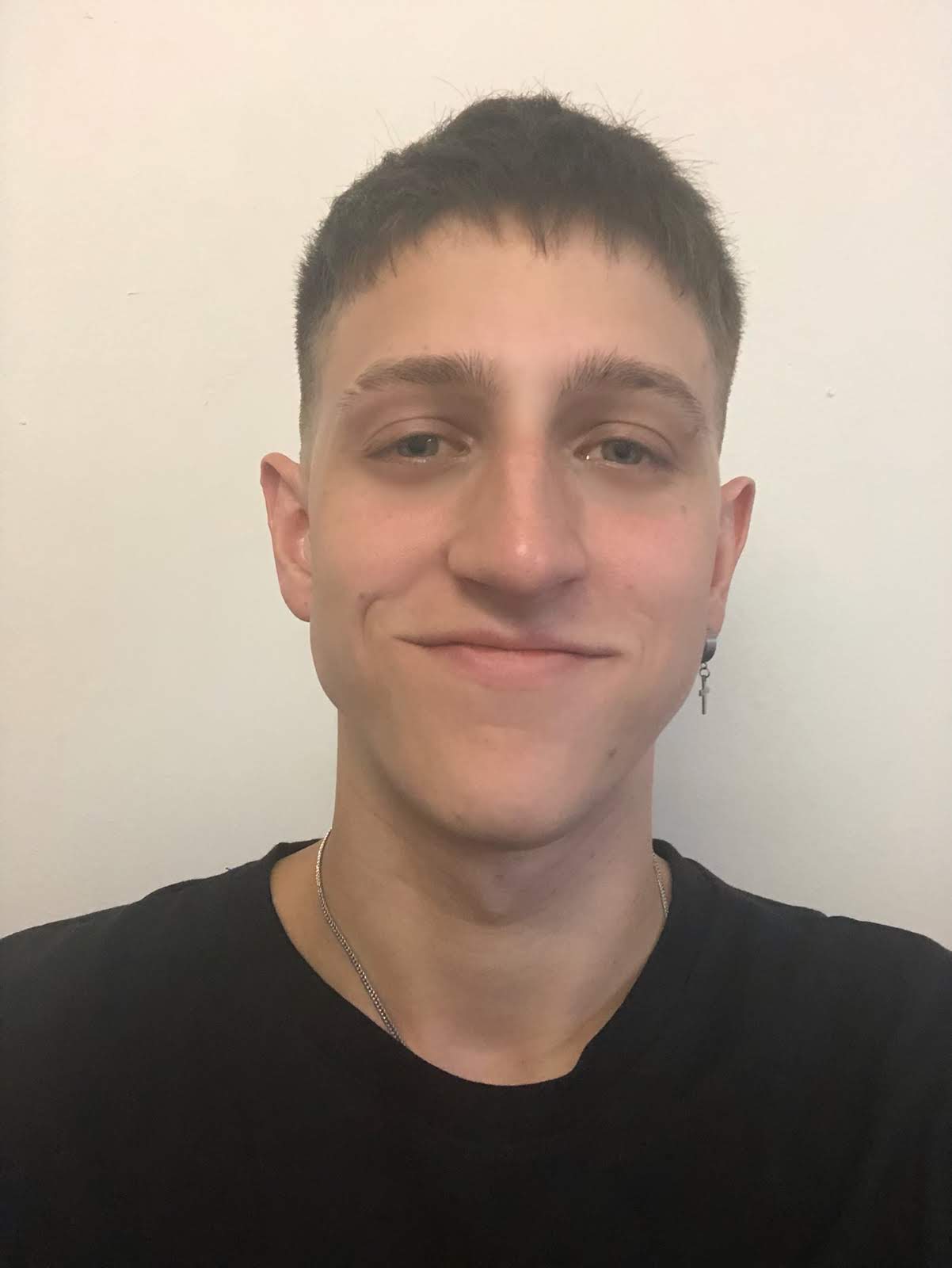 Francisco Andreo smiling in a black t-shirt